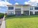 Well-maintained condo with a lush green lawn and inviting screened in porch, perfect for outdoor living at 6177 Sun Blvd # 108, St Petersburg, FL 33715