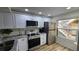 Updated kitchen with modern stainless appliances and granite counters at 6177 Sun Blvd # 108, St Petersburg, FL 33715
