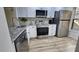 Modern kitchen featuring stainless steel appliances and stone counters at 6177 Sun Blvd # 108, St Petersburg, FL 33715