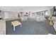Large lounge with seating arrangements, tables, and access to balconies, creating a comfortable community space at 6177 Sun Blvd # 108, St Petersburg, FL 33715