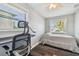 Bedroom featuring a bed, a desk, and natural light from two windows at 644 Bayshore Dr, Tarpon Springs, FL 34689