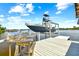 Boat lift with a wash station and a gray boat at 644 Bayshore Dr, Tarpon Springs, FL 34689