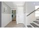 Charming entryway with white wood paneling and tile floors leads to stairwell at 644 Bayshore Dr, Tarpon Springs, FL 34689