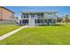 Two-story home with a spacious screened-in lanai and large backyard at 644 Bayshore Dr, Tarpon Springs, FL 34689