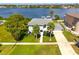 Stunning waterfront home featuring a spacious lawn, mature trees, and private dock at 644 Bayshore Dr, Tarpon Springs, FL 34689