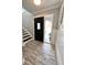 Inviting home foyer featuring wood-look tile flooring, and natural light from front door at 644 Bayshore Dr, Tarpon Springs, FL 34689