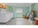 Bright laundry room with white washer and dryer, and water heater at 644 Bayshore Dr, Tarpon Springs, FL 34689