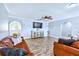 Spacious living room with hardwood floors, a ceiling fan, and an elegant cabinet at 644 Bayshore Dr, Tarpon Springs, FL 34689