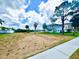 Vacant lot featuring palm trees and waterfront views, ready for building your dream home at 644 Bayshore Dr, Tarpon Springs, FL 34689