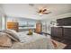 A spacious main bedroom featuring hardwood floors, natural light, ceiling fan, with walk-out patio at 644 Bayshore Dr, Tarpon Springs, FL 34689