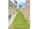 Narrow side yard with grass, rocks, and a privacy fence at 644 Bayshore Dr, Tarpon Springs, FL 34689
