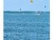 A water view showing blue water with individuals parasailing and boating in the background at 644 Bayshore Dr, Tarpon Springs, FL 34689