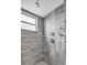 Modern bathroom featuring gray tile, a window, and dual shower heads at 8717 Velvet Dr, Port Richey, FL 34668