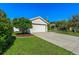 One story home with a two-car garage, nicely landscaped yard, and walkway at 7187 50Th Avenue E Cir, Palmetto, FL 34221