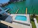 Community pool with water access and lounge chairs at 211 Dolphin Pt # 203, Clearwater, FL 33767