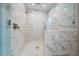 Large walk-in shower with marble tile and glass enclosure at 2316 Kent Pl, Clearwater, FL 33764