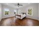 Bedroom with hardwood floors, antique bed, and multiple windows at 2316 Kent Pl, Clearwater, FL 33764