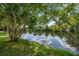 Serene pond view with lush greenery and reflection at 2316 Kent Pl, Clearwater, FL 33764