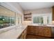 Kitchen with expansive windows, custom cabinetry, and granite countertops at 2316 Kent Pl, Clearwater, FL 33764