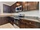 Kitchen with stainless steel appliances and dark wood cabinets at 12235 Creek Preserve Dr, Riverview, FL 33579