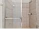 Shower stall with glass door and neutral tile at 12235 Creek Preserve Dr, Riverview, FL 33579