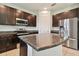 Modern kitchen features stainless steel appliances and granite countertops at 12235 Creek Preserve Dr, Riverview, FL 33579