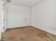 Simple bedroom with neutral walls and carpet, plus a door at 12235 Creek Preserve Dr, Riverview, FL 33579