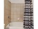Shower/tub combo with neutral tile and striped curtain at 12235 Creek Preserve Dr, Riverview, FL 33579