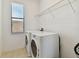 Laundry room with washer, dryer, and overhead shelving at 12235 Creek Preserve Dr, Riverview, FL 33579