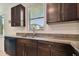 Modern kitchen with dark wood cabinets, granite countertops, and stainless steel appliances at 12235 Creek Preserve Dr, Riverview, FL 33579
