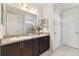 Bathroom with dark wood vanity and large mirror at 12235 Creek Preserve Dr, Riverview, FL 33579