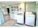 Bright laundry room with side by side washer and dryer at 644 Bayshore Dr, Tarpon Springs, FL 34689