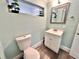 Small bathroom with toilet and updated vanity at 644 Bayshore Dr, Tarpon Springs, FL 34689