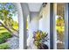 Covered front porch with a bench and potted plants at 644 Bayshore Dr, Tarpon Springs, FL 34689
