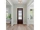 Bright entryway featuring a dark wood door and wood-look floors at 160 26Th N Ave, St Petersburg, FL 33704