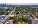 Aerial view of a vacant lot nestled among mature trees in a residential area with a clear view of the city at 705 W Amelia Ave, Tampa, FL 33602