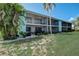 Exterior view of the building showcasing a teal facade at 1730 Manasota Beach Rd # 115, Englewood, FL 34223