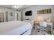 Bright bedroom with a comfortable bed, work desk, and large TV at 1730 Manasota Beach Rd # 115, Englewood, FL 34223