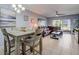 Bright dining area with a table and four chairs, adjacent to the living room at 1730 Manasota Beach Rd # 115, Englewood, FL 34223