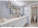 Clean bathroom with white cabinets and a large vanity at 1730 Manasota Beach Rd # 115, Englewood, FL 34223