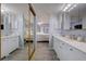 Large bathroom with double sinks and a mirrored wall at 1730 Manasota Beach Rd # 115, Englewood, FL 34223