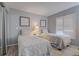 Bedroom with two twin beds and window with plantation shutters at 1730 Manasota Beach Rd # 115, Englewood, FL 34223
