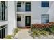 Condo building exterior, unit 115, featuring a walkway and landscaping at 1730 Manasota Beach Rd # 115, Englewood, FL 34223