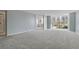 Living Room with gray carpet and large windows at 660 Island Way # 301, Clearwater Beach, FL 33767