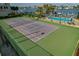 Well-maintained tennis court with green surface and surrounding fence at 660 Island Way # 301, Clearwater Beach, FL 33767