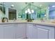 Double vanity bathroom with modern fixtures and a large mirror at 4450 Gulf Blvd # 104, St Pete Beach, FL 33706