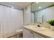 Clean bathroom with white vanity, shower, and toilet at 4450 Gulf Blvd # 104, St Pete Beach, FL 33706