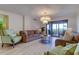 Bright living room with hardwood floors, comfy seating, and large windows at 4450 Gulf Blvd # 104, St Pete Beach, FL 33706