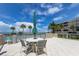 Relaxing patio area with table and chairs and ocean views at 4450 Gulf Blvd # 104, St Pete Beach, FL 33706