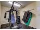 Small gym with weight machine, dumbbells, and exercise mats at 4450 Gulf Blvd # 104, St Pete Beach, FL 33706